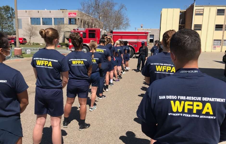 Picture of people lining up to begin firefighter training skills