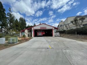 Front of fire station 39 with bay doors open and fire engine inside the bay.